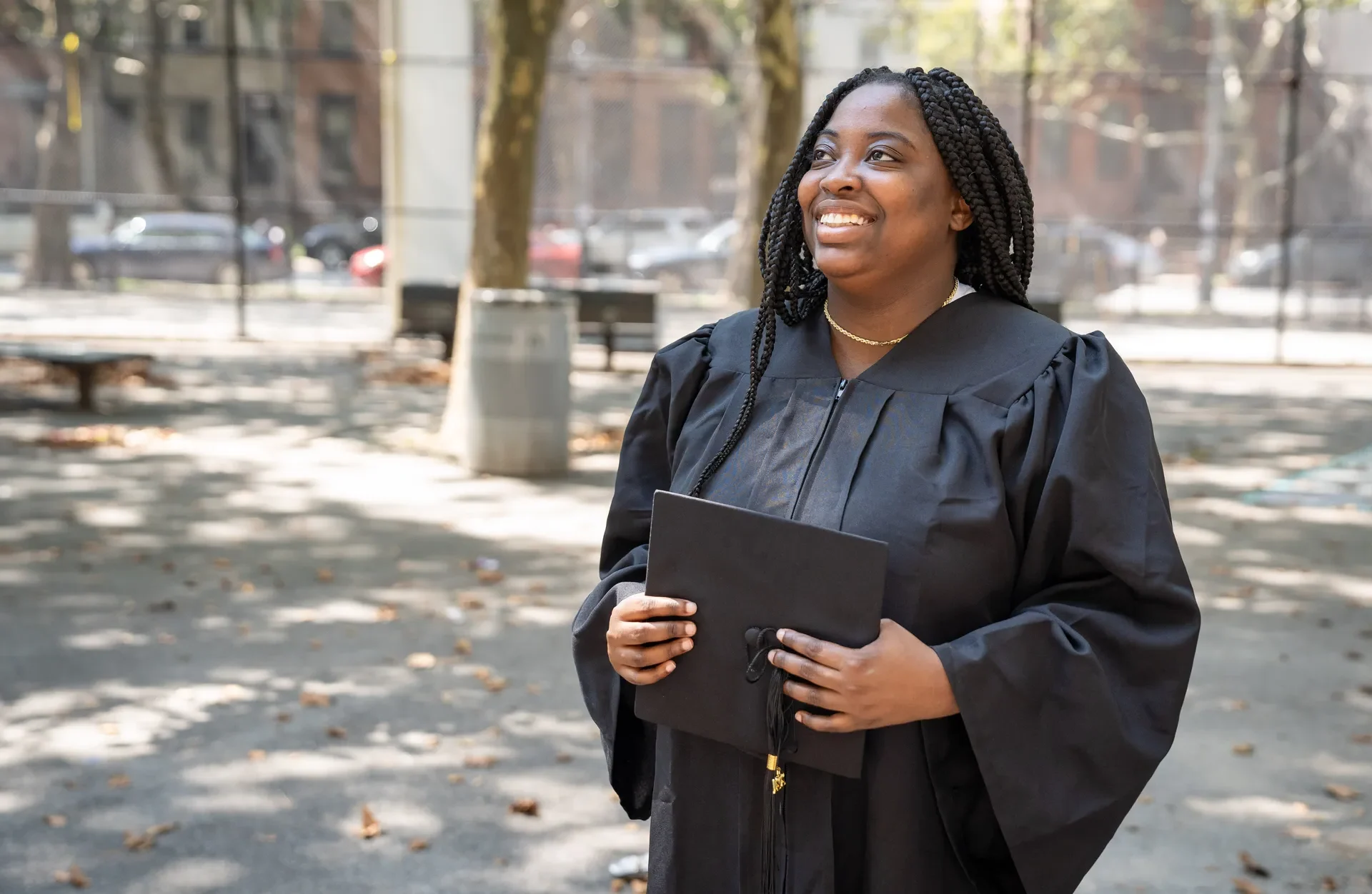 Happy graduate holding her cap.